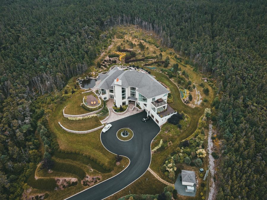 Aerial view of an estate acreage surrounded by forest