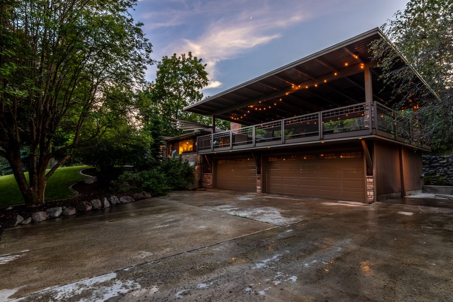 Executive home with covered deck at dusk